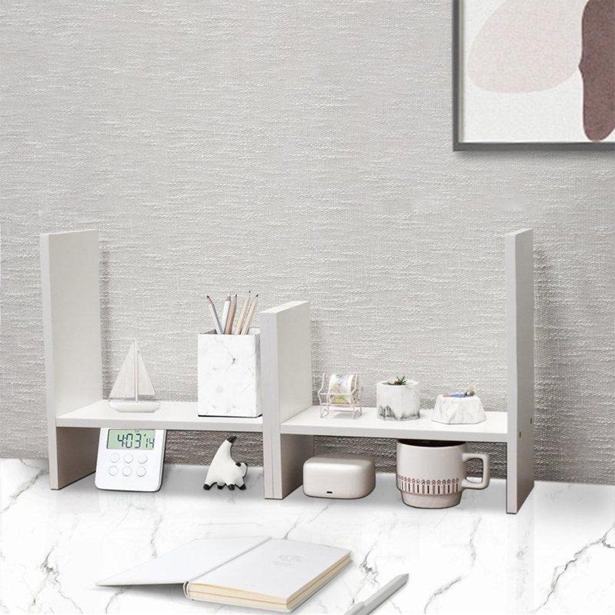 White desk organizer styled with stationery and mug on a desk
