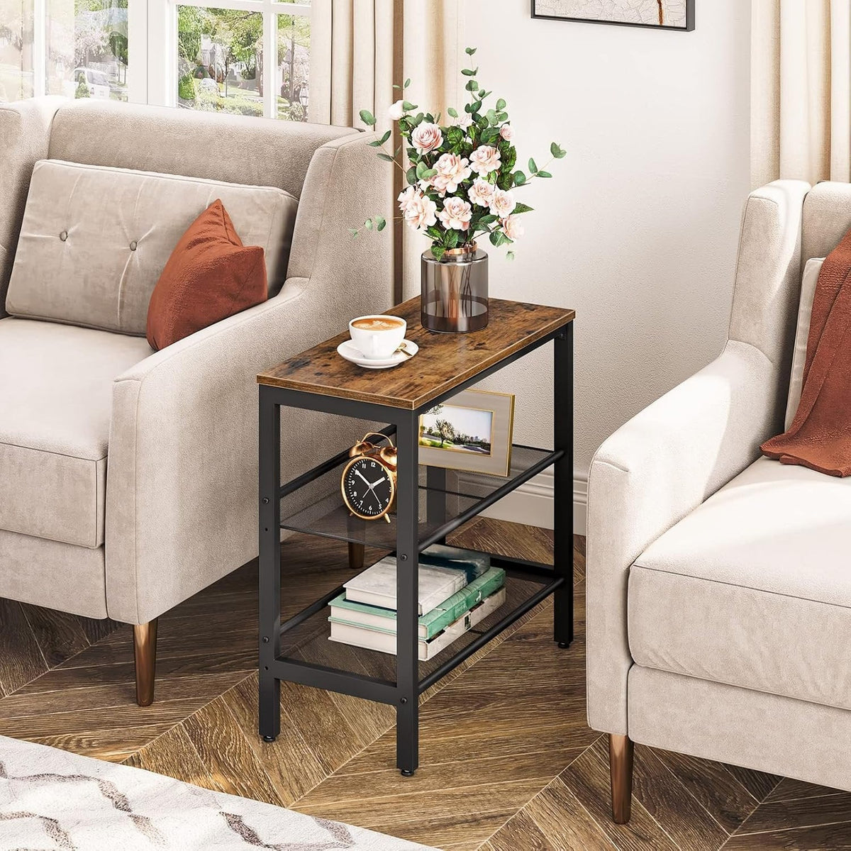 Narrow wooden side table styled between armchairs in a living room