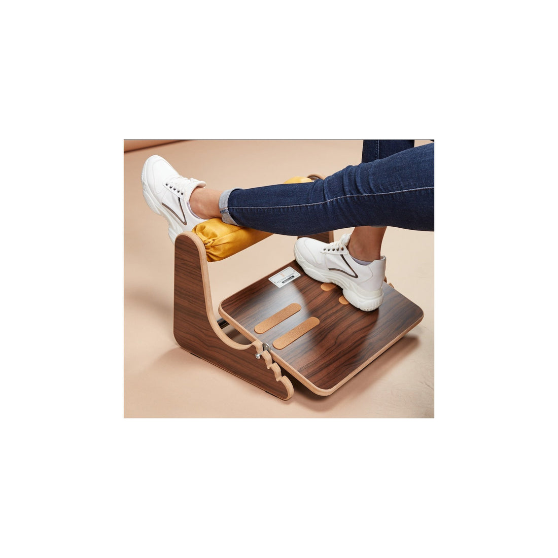 Person using the wooden footrest under a desk